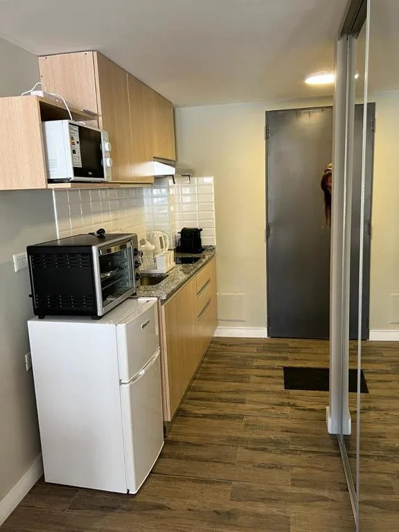 Cocina equipada del departamento de Güemes 540 con horno eléctrico, microondas y cafetera